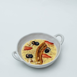Oatmeal with whole milk with caramelized banana and berries