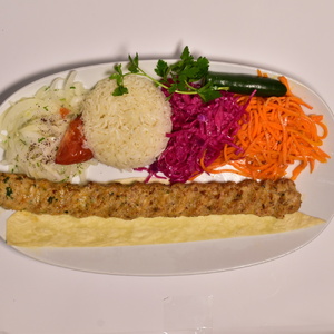 Chicken skewers in earthenware bowl